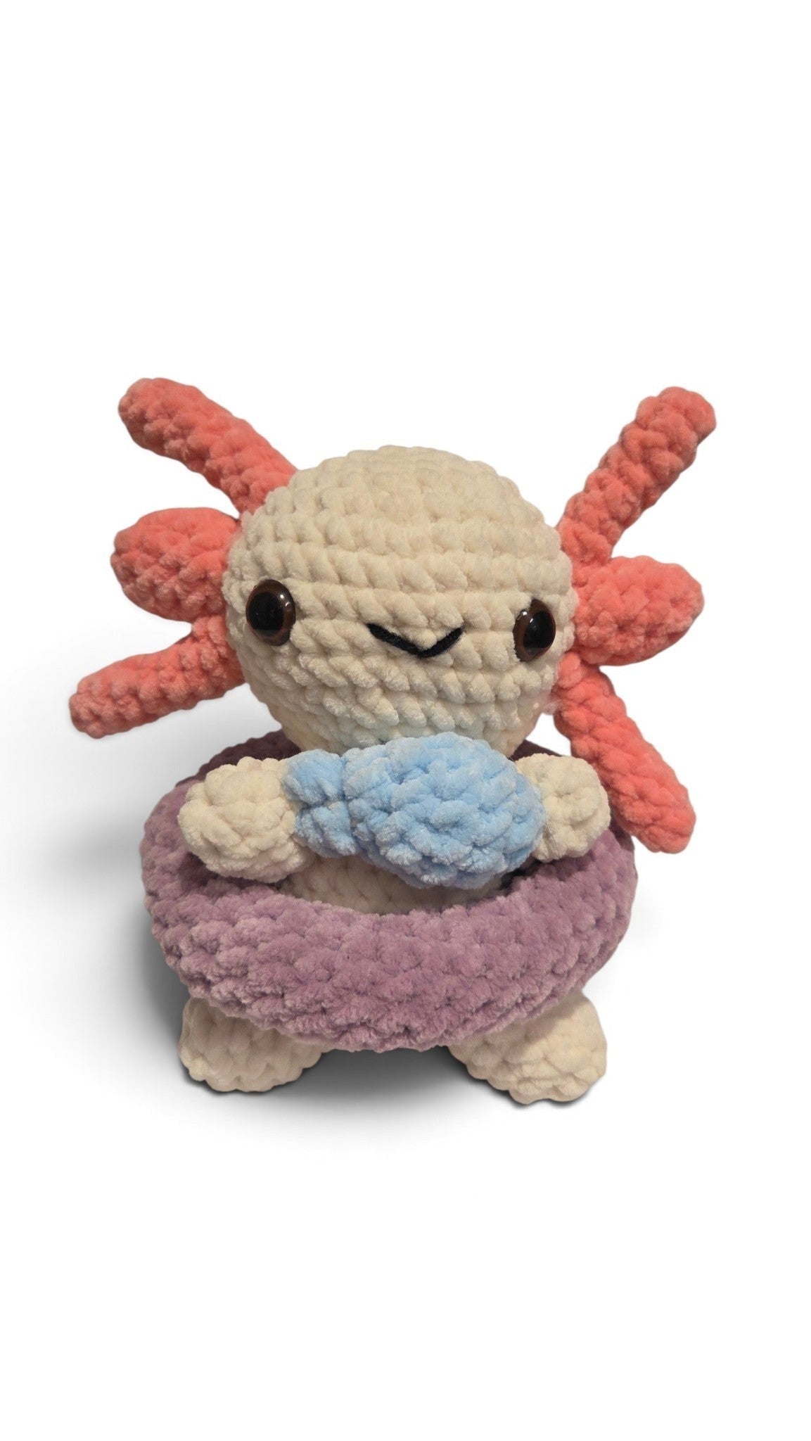 BrainRotPop handmade crochet axolotl plush toy in off-white with coral-pink gills and a purple swimming ring.