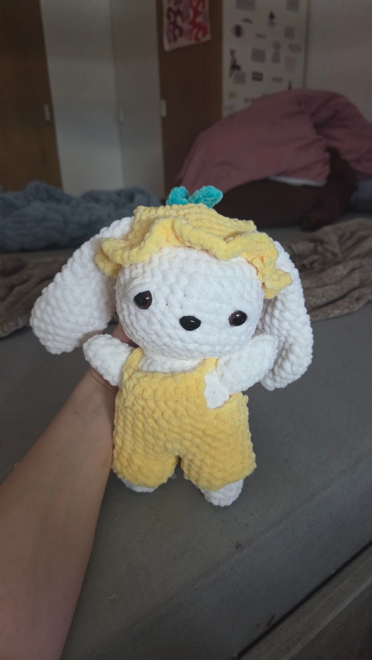 BrainRotPop handmade white crochet bunny plushie wearing yellow dungarees and a matching sun hat with a teal bow
