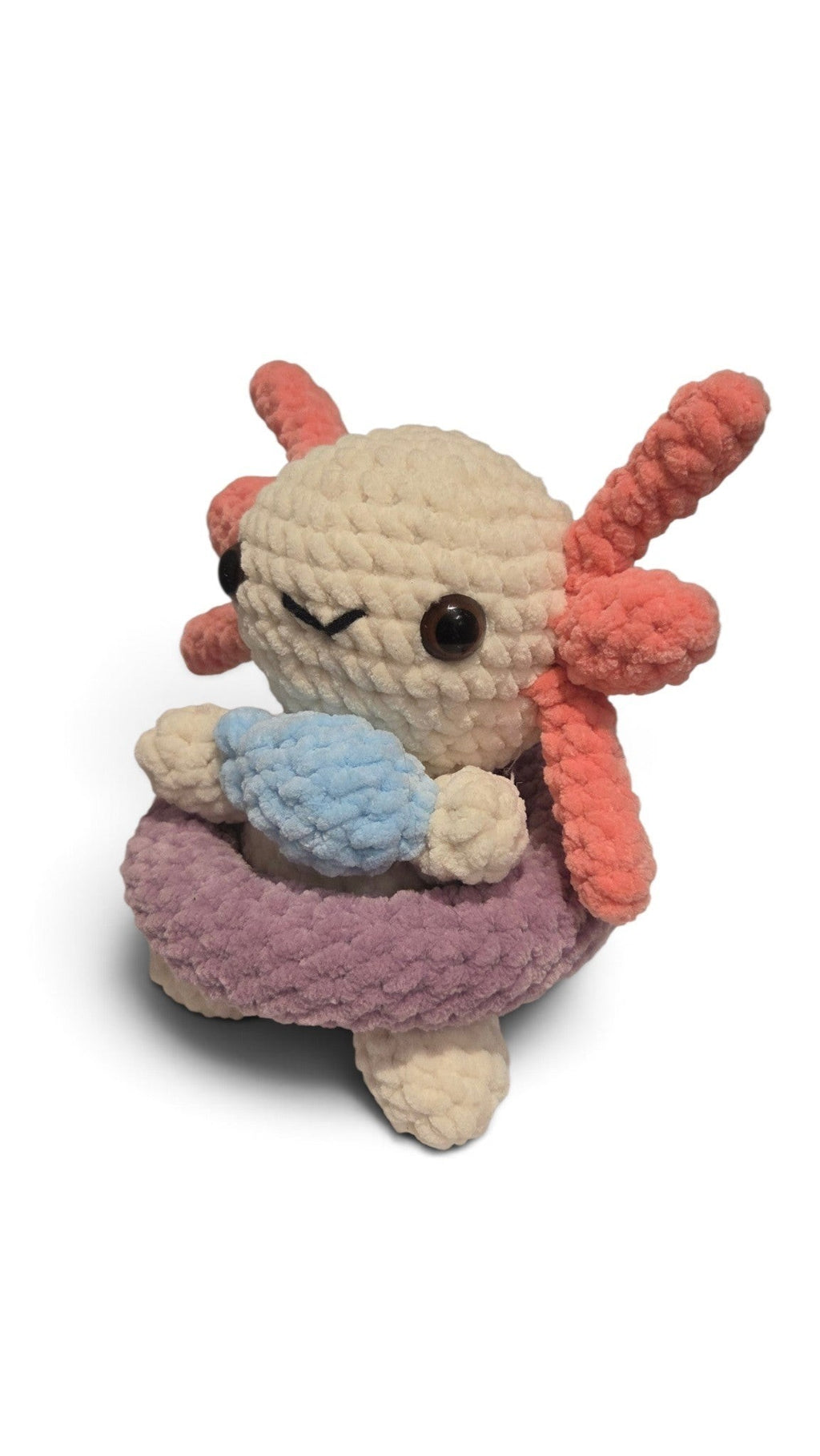 BrainRotPop handmade crochet axolotl plush toy in off-white with coral-pink gills and a purple swimming ring.