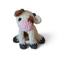 BrainRotPop handmade crochet cow plush toy in cream and brown chenille yarn with a soft pink snout.